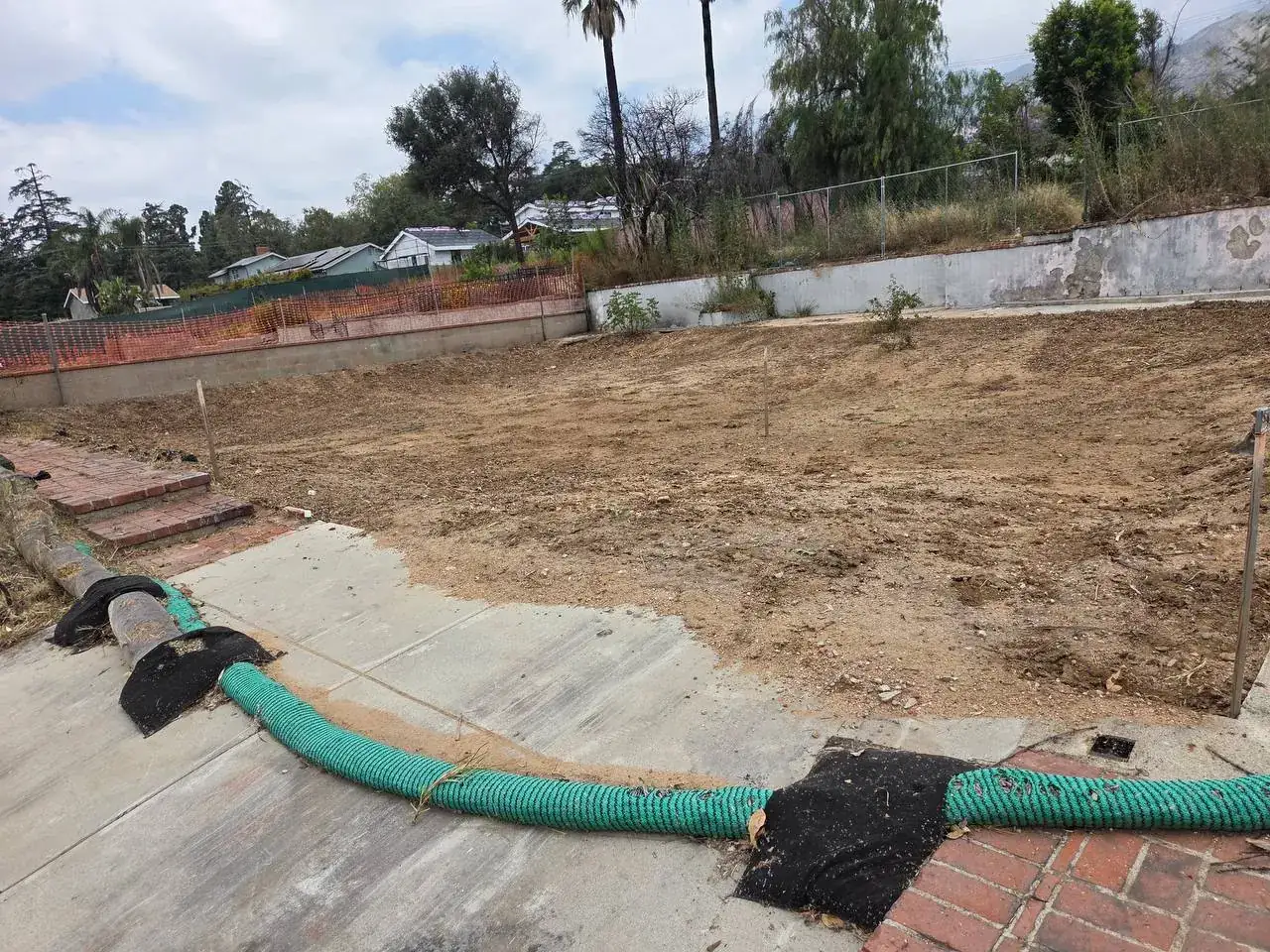 Cleared backyard retaining wall after
