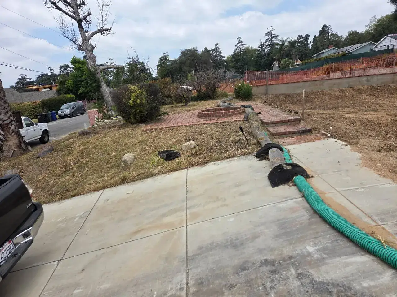 A cleared front yard with a brick patio after a cleanup